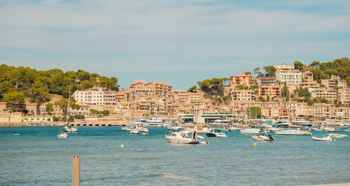 Sailboats and yachts moored in a Mediterranean harbour town