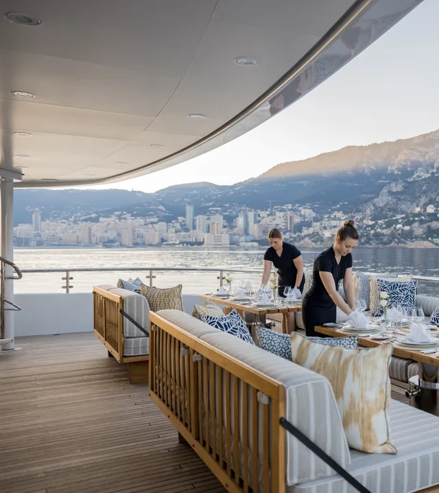 Stewardesses setting the aft deck table